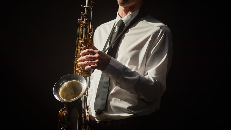 Male Musician in Shirt Playing Saxophone on Stage in Spotlight against BlackCropped shot of male musician dressed in formal white shirt and black tie pushing keys of shiny saxophone with nimble fingers creating enchanting jazz music in hard stage light, copy spaceman, musician, artist, saxophone, play, music, instrument, performance, stage, black, background, woodwind, brass, studio, shirt, saxophonist, concert, art, jazz, spotlight, wind, formal, classic, light, contrast, male, tie, clothes, professional, sax, metal, alto, tenor, saxist, blow, bronze, golden, shine, key, live, orchestra, sound, melody, elegance, contemporary, philharmonic, acoustic, entertainment, cropped, unrecognizable, man, musician, artist, saxophone, play, music, instrument, performance, stage, black, background, woodwind, brass, studio, shirt, saxophonist, concert, art, jazz, spotlight, wind, formal, classic, light, contrast, male, tie, clothes, professional, sax, metal, alto, tenor, saxist, blow, bronze, golden, shine, key, live, orchestra, sound, melody, elegance, contemporary, philharmonic, acoustic, entertainment, cropped, unrecognizable