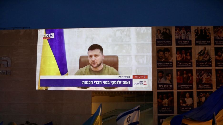 TEL AVIV, ISRAEL - MARCH 20: People gather to watch Ukrainian President Volodymyr Zelenskyâs speech on Knesset ( Israelâs parliament) via video conference in Tel Aviv, Israel on March 20, 2022. A giant screen is set up at Habima Square. (Photo by Mostafa Alkharouf/Anadolu Agency via Getty Images)