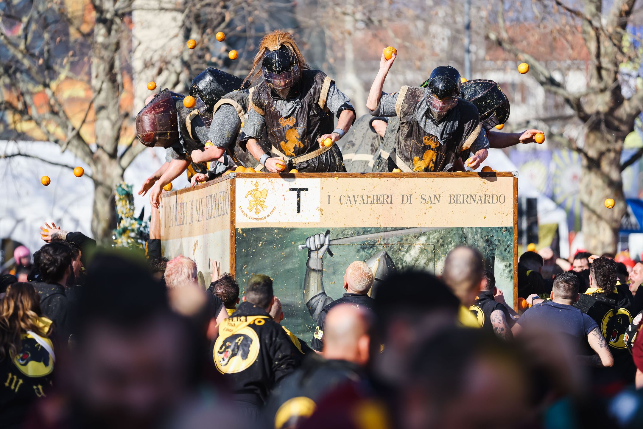 People are attending the Battle of the Oranges during The Historical Carnival of Ivrea in Ivrea, Italy, on February 19, 2023. (Photo by Alessandro Bremec/NurPhoto via Getty Images)
