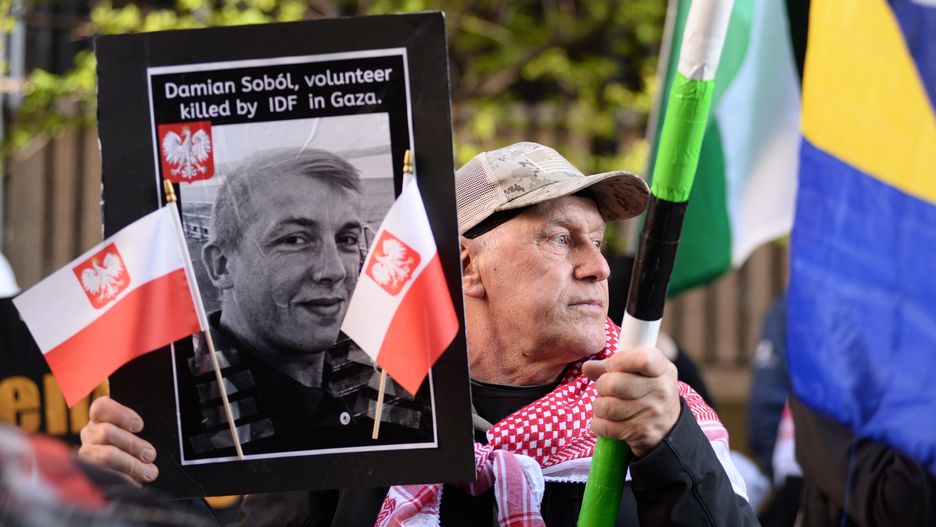 CHICAGO, ILLINOIS - APRIL 5: A protester holds a photo of Damian Sobol from World Central Kitchen during a pro-Palestinian protest outside the Israeli consulate in Chicago, Illinois, United States on April 5, 2024. Damian Sobol was a Polish volunteer who was killed during a humanitarian mission in Gaza on April 1, 2024. (Photo by Jacek Boczarski/Anadolu via Getty Images)