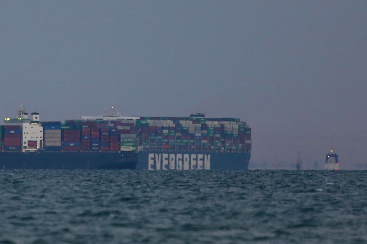 The Ever Given container ship, right, enters the Great Bitter Lake after being freed from the Suez Canal in Suez, Egypt, on Monday, March 29, 2021. The giant Ever Given container ship was finally pulled free from the bank of the Suez Canal, allowing for a massive tail back of ships to start navigating once again through one of the worlds most important trade routes. Photographer: Islam Safwat/Bloomberg via Getty Images