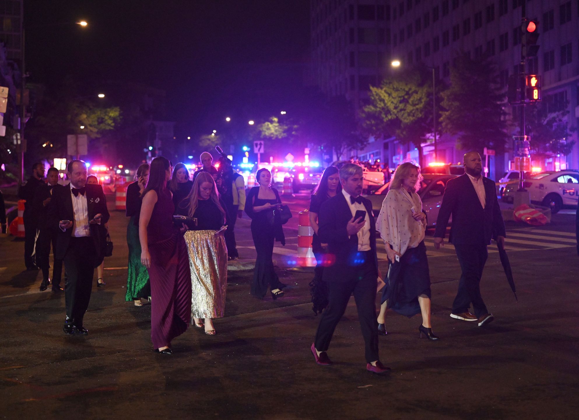 WASHINGTON, DC - APRIL 25: Guests walk away from the Washington Hilton Hotel amid a heavy police presence after shots were heard during the White House Correspondents' Dinner on April 25, 2026 in Washington, D.C. US President Donald Trump and Vice President JD Vance were evacuated from the White House Correspondents' Association dinner in Washington on April 25 following a security incident at the venue. (Photo by Chen Mengtong/China News Service/VCG via Getty Images)