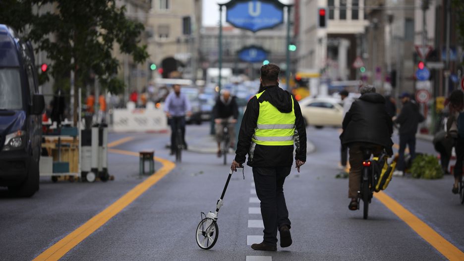 BERLIN, GERMANY - AUGUST 27: People walk on a five-block stretch of Friedrichstrasse that has been sealed off to motorists in preparation for an experiment in reducing the amount of vehicle traffic in the city center on August 27, 2020 in Berlin, Germany. Workers are currently preparing street markings and other signage ahead of the official launch on August 29. Friedrichstrasse is one of the main shopping streets in central Berlin and the five-block section will be closed to motorists until the end of January. City authorities will assess the impact of the closure on neighbouring traffic. (Photo by Omer Messinger/Getty Images)
