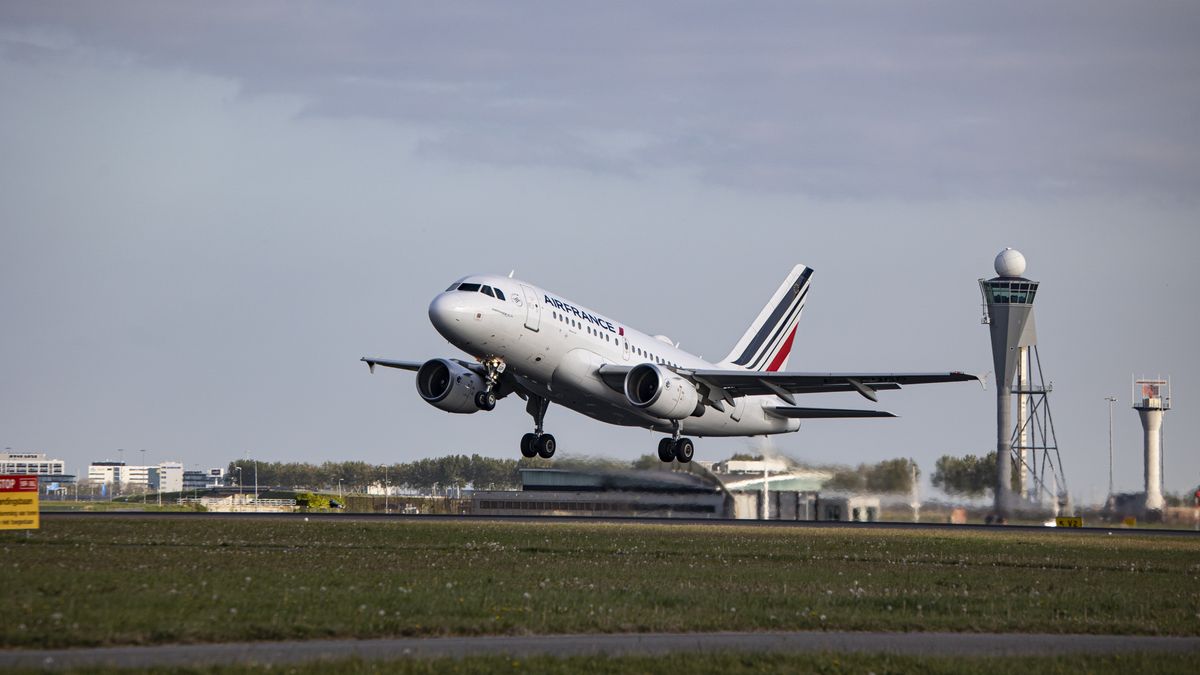 Air France Airbus A318 aircraft as seen during take off and flying phase from Amsterdam Schiphol Airport. The narrow body A318 is departing from Polderbaan runway and passes in front of the control tower performing a flight to Paris. AirFrance AF AFR is the French airline flag carrier, subsidiary of Air France-KLM Group and member of SkyTeam aviation alliance. As the Covid-19 Coronavirus pandemic measures are suspended the aviation, travel and tourism industry are having increased demand for flights. Since May 16, 2022 the mandatory usage of facemasks in airplane and airport is lifted.  Amsterdam, the Netherlands on April 27, 2022  (Photo by Nicolas Economou/NurPhoto via Getty Images)