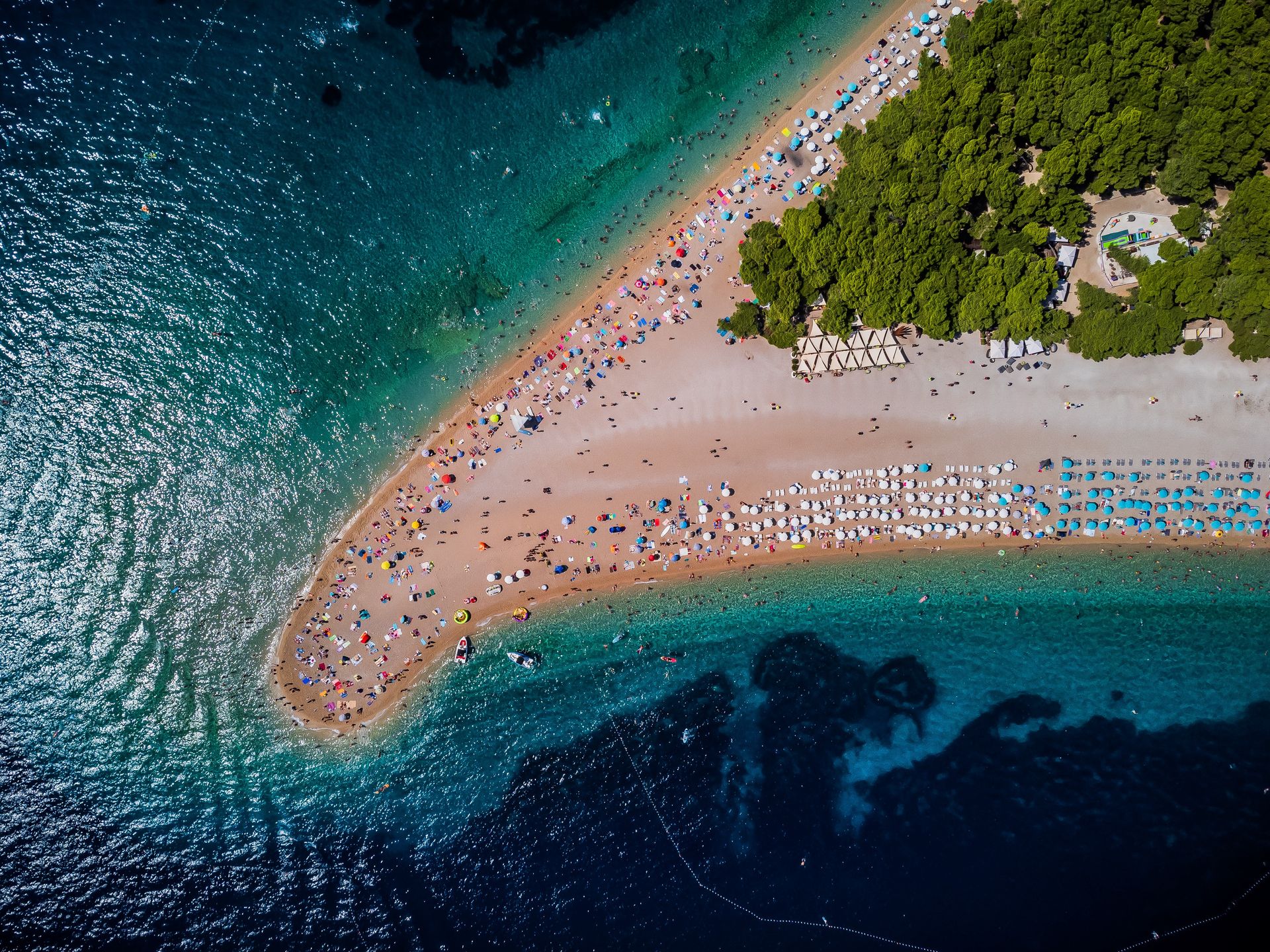 Tourists are seen on a beach known as Zlatni rat (Golden Horn) near Bol at the Croatian Adriatic island of Brac, 450 km (280 miles) southeast from the capital Zagreb on August 27, 2023. (Photo: Zvonimir Barisin/PIXSELL/DeFodi Images News via Getty Images)