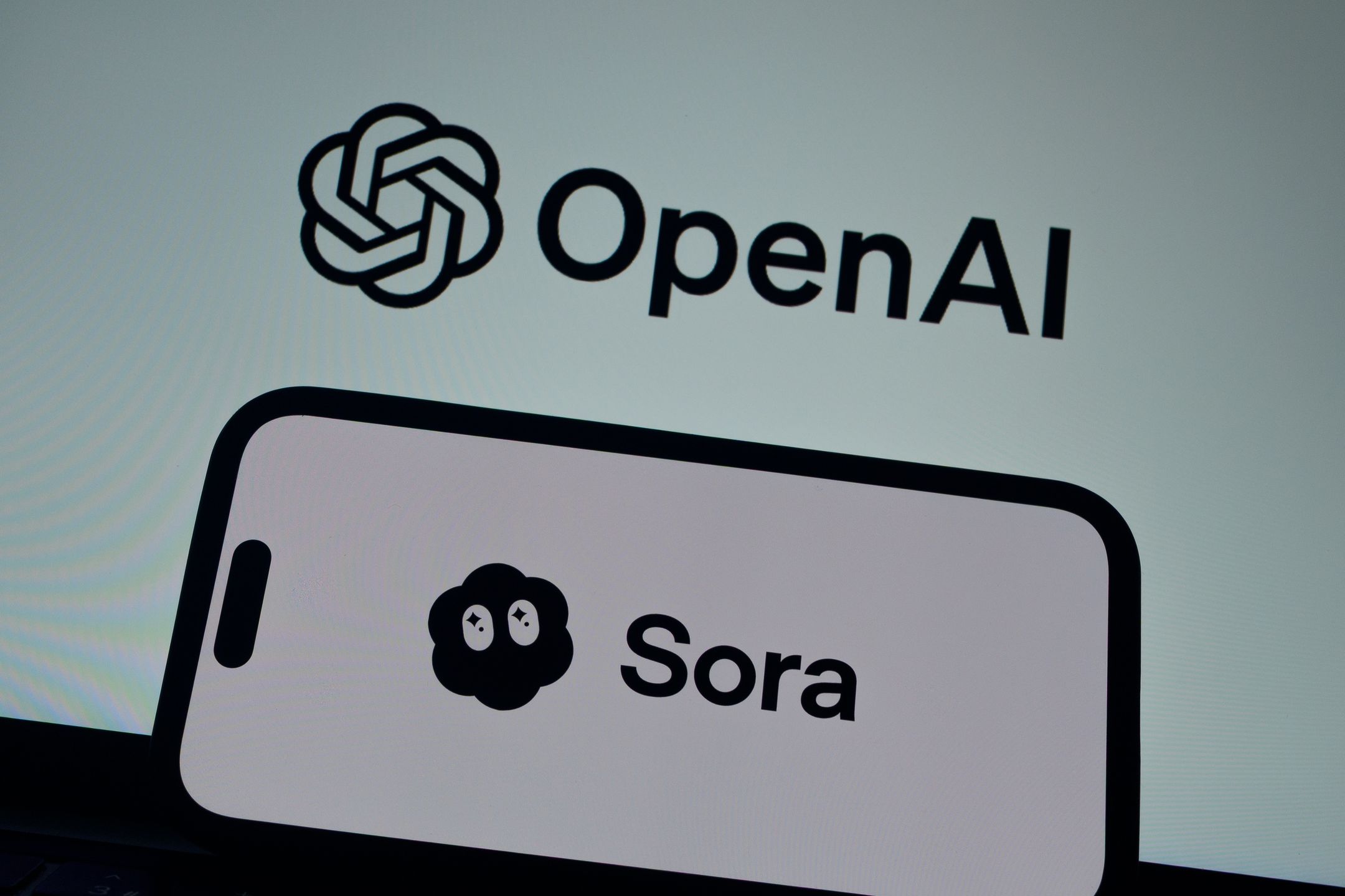 ANKARA, TURKIYE - FEBRUARY 5: In this photo illustration, the Sora logo is being displayed on a mobile phone screen in front of a computer screen displaying OpenAI logo in Ankara, Turkiye on February 5, 2026. (Photo by Ahmet Serdar Eser/Anadolu via Getty Images)