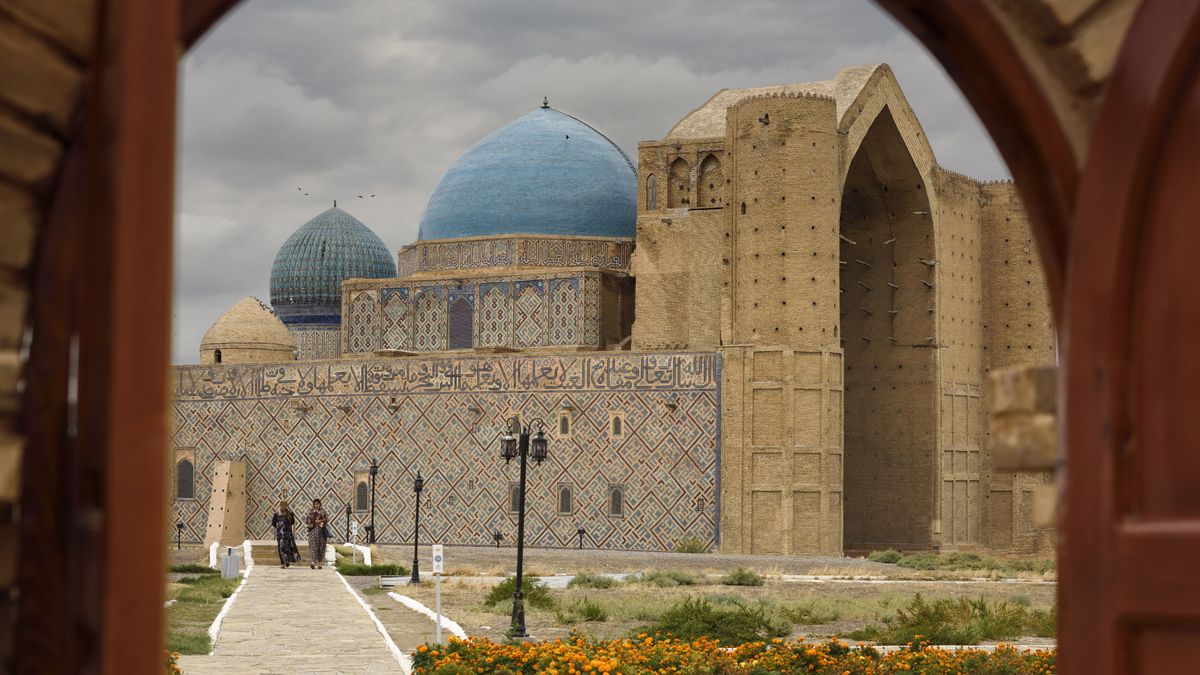 Khoja Ahmed Yasawi Mausoleum through the doors, Turkestan Kazakhstan
Khoja Ahmed Yasawi Mausoleum through the doors of the architectural museum Turkestan Kazakhstan. (Photo by: Education Images/Universal Images Group via Getty Images)
Education Images
national, complex, architectural, state, historical, cultural, reserve, azret sultan, turkestan, khoja, ahmed, yasawi, khawajah, akhmet, yassawi, ahmad, yasavi, yasaui, yassaui, hodja, khawaja, turquoise, blue green, domes, unfinished, geometric, patterns, turkistan, two women, clouds