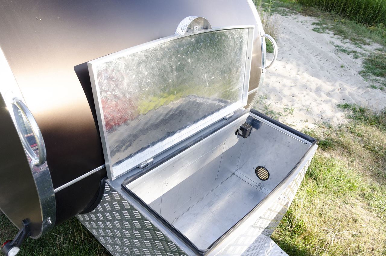 A spacious chest for a refrigerator and other odds and ends is standard equipment for this model.