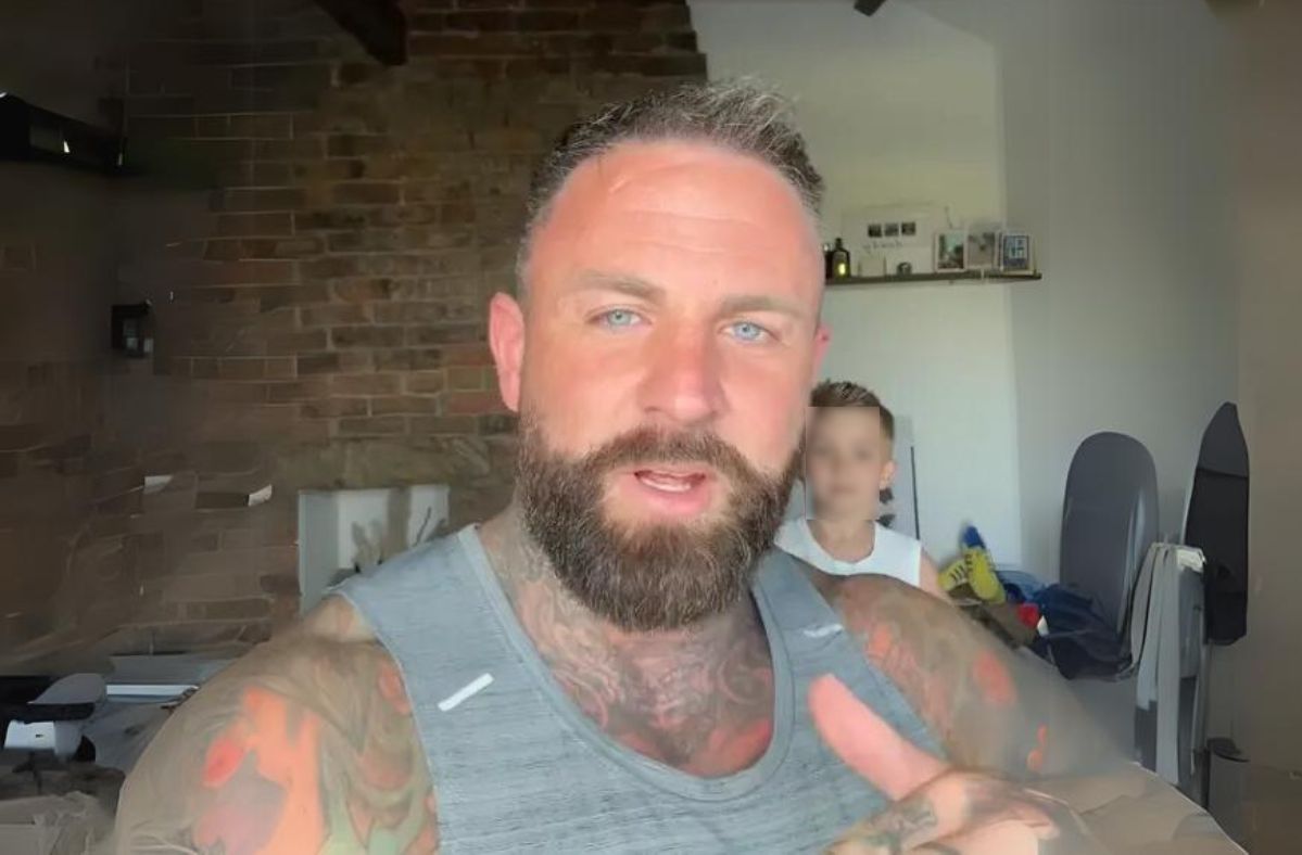 Tattooed TikToker dad stands firm against critics over kissing son on the lips