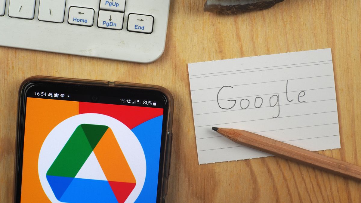 GERMANY - 2023/09/17: In this photo illustration, a Google Drive logo is seen displayed on a smartphone next to a Google inscription piece of paper. (Photo Illustration by Valera Golovniov/SOPA Images/LightRocket via Getty Images)