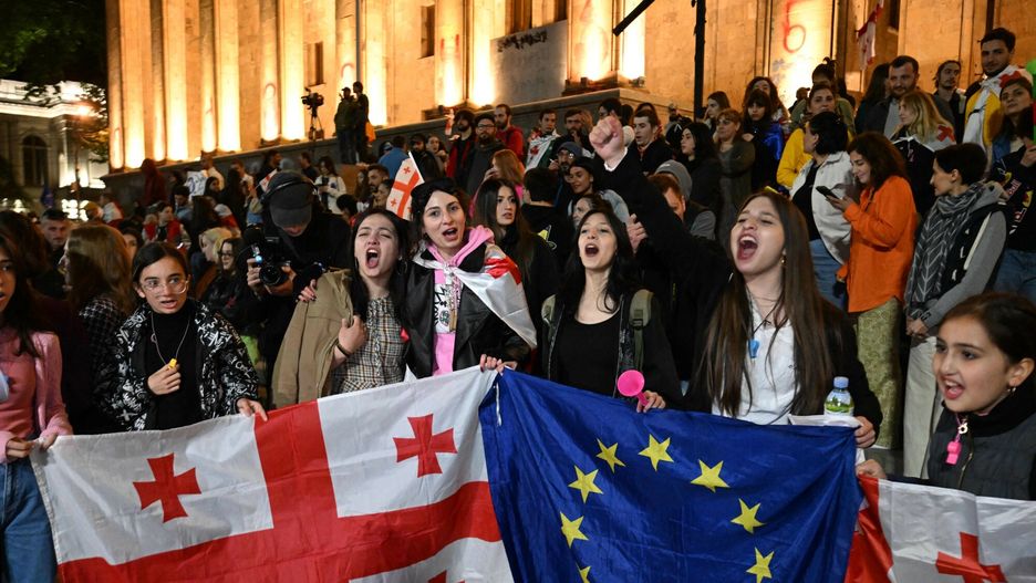 Temporary
Protestors chant as they demonstrate against the "foreign influence" law, outside the Georgian Parliament in Tbilisi, on May 18, 2024. Georgian President Salome Zurabishvili on May 18, 2024 put a mostly symbolic veto on the "foreign influence" law that sparked unprecedented protests and warnings from Brussels that the measure would undermine Tbilisi's EU aspirations.Ruling Georgian Dream party lawmakers voted through the legislation on May 14, 2024 in defiance of protesters concerned the ex-Soviet republic is shifting away from a pro-Western course back toward Russia, sparking a wave of protests unprecedented in the recent history of the Black Sea nation.



Weeks-long mass protests continue against the "foreign influence" law after Georgian Dream party lawmakers voted through the legislation on May 14, 2024 in defiance of protesters worried the Caucasus country is shifting away from a pro-Western course towards Russia. (Photo by Vano SHLAMOV / AFP)
VANO SHLAMOV