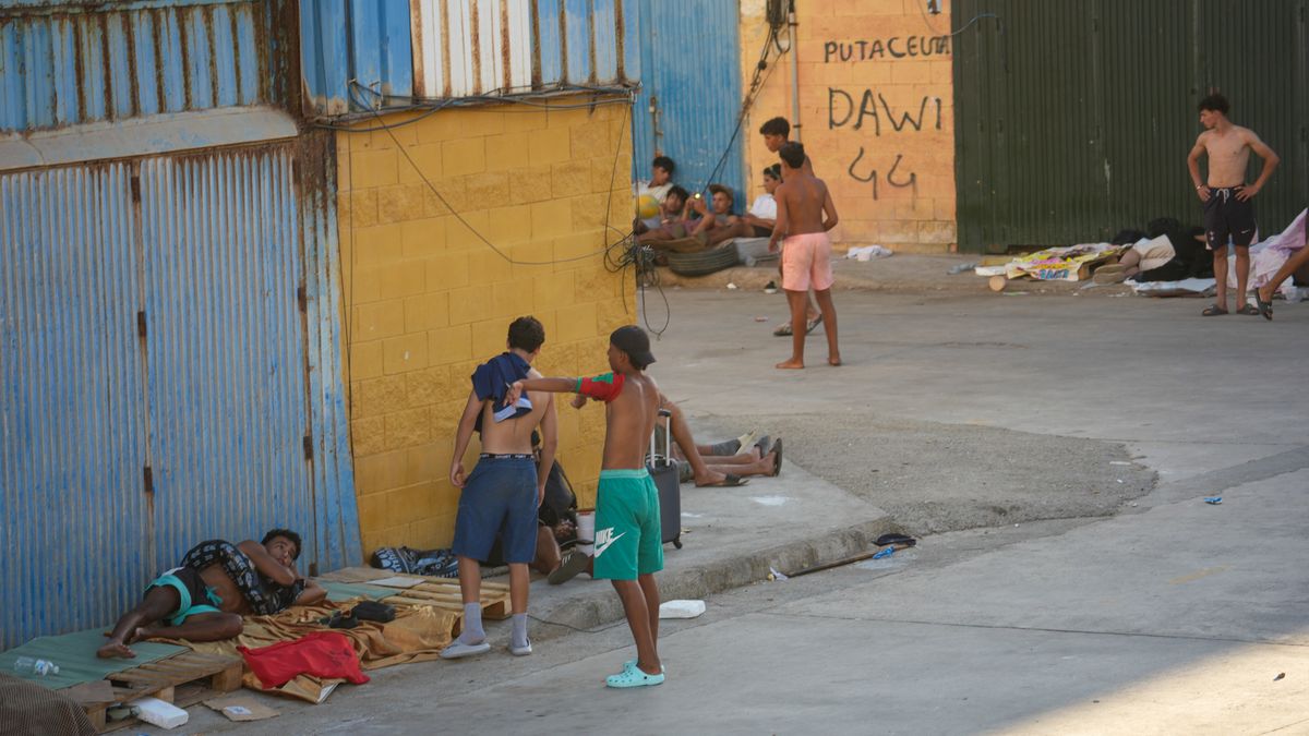 Young migrants and children gather in an industrial area in Ceuta, Spain, on August 3. Most are Moroccan nationals, including many unaccompanied minors, who are waiting for assistance while living in the streets of Ceuta after crossing from Morocco at the end of July. (Photo by Ana Lopez/NurPhoto via Getty Images)