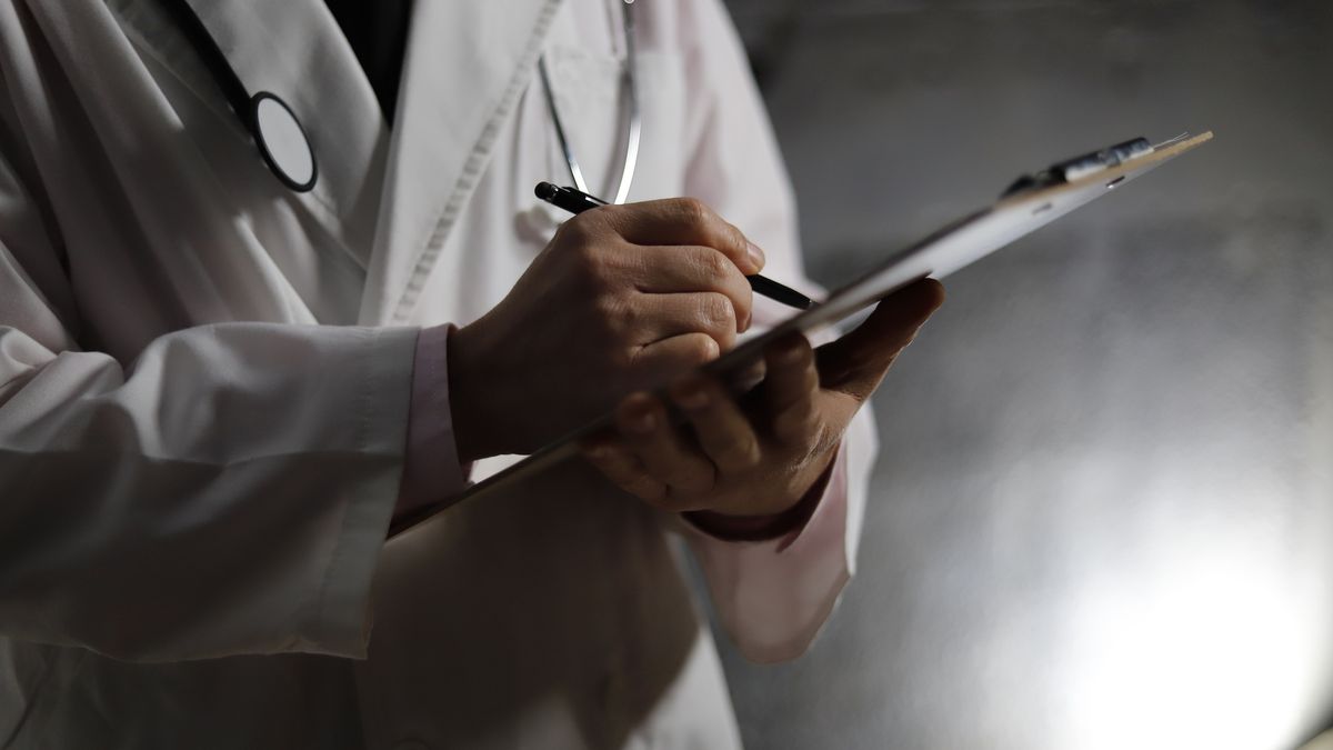 Close up of doctor writing on chart
RunPhoto