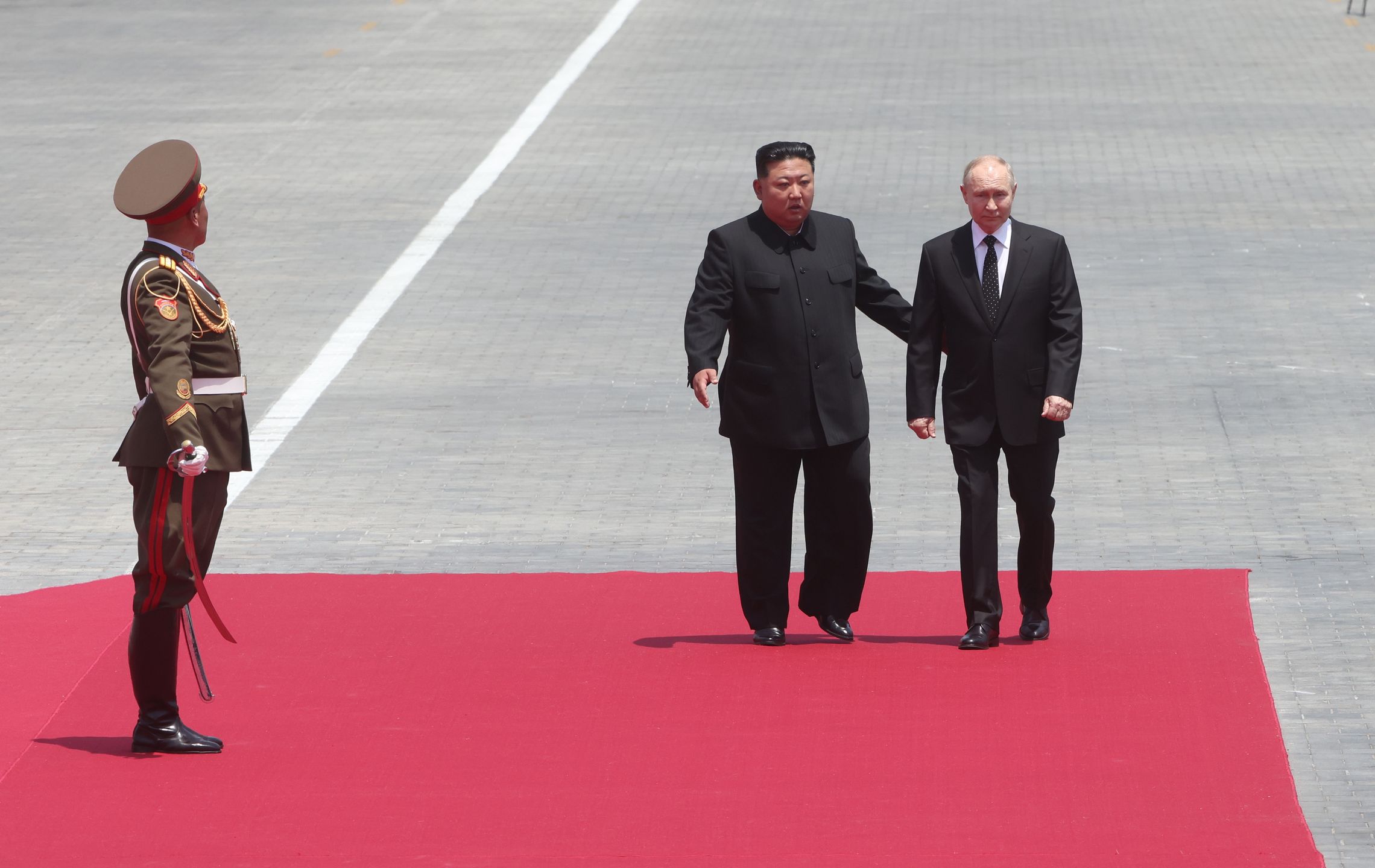 PYONGYANG, NORTH KOREA - JUNE 19: (RUSSIA OUT) Russia's President Vladimir Putin (R) and North Korean Supreme Leader Kim Jong Un (C) attend a welcoming ceremony, on June 19, 2024, in Pyongyang, North Korea. Russian President Vladimir Putin is in North Korea for a two-day visit. (Photo by Contributor/Getty Images)