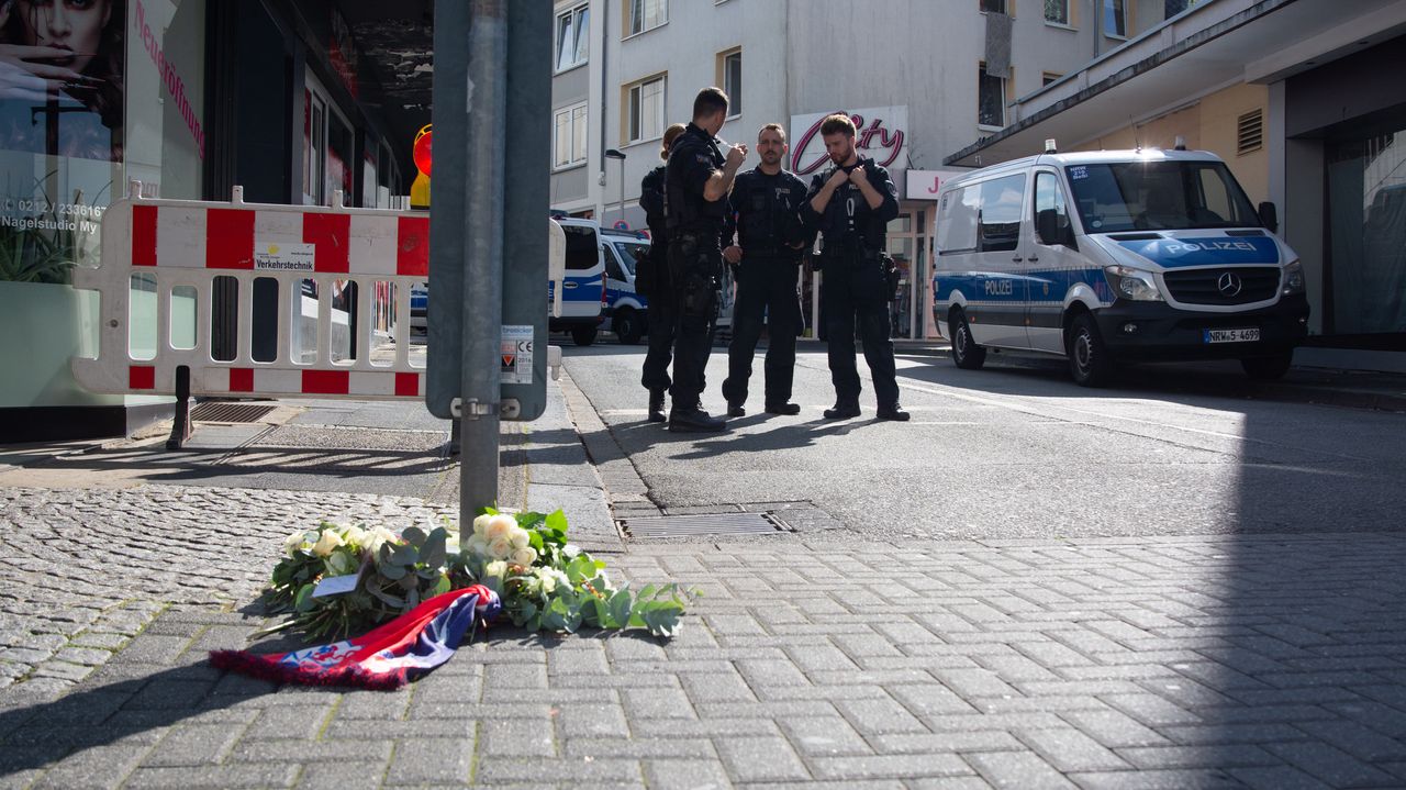 People bring flowers to the crime scene.