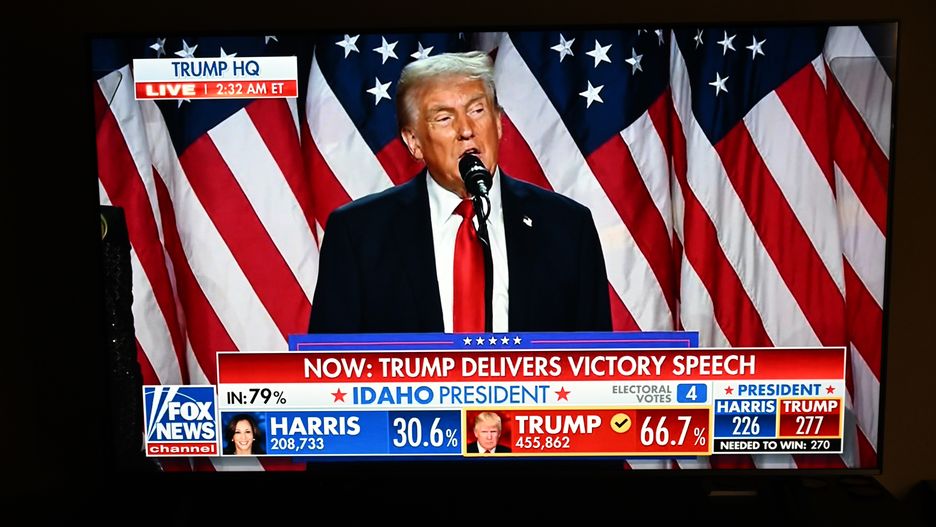 FOSTER CITY, CALIFORNIA - NOVEMBER 5: A couple watch President Donald Trump's victory speech from a TV screen in Foster City, California, United States on November 5, 2024. (Photo by Tayfun Coskun/Anadolu via Getty Images)