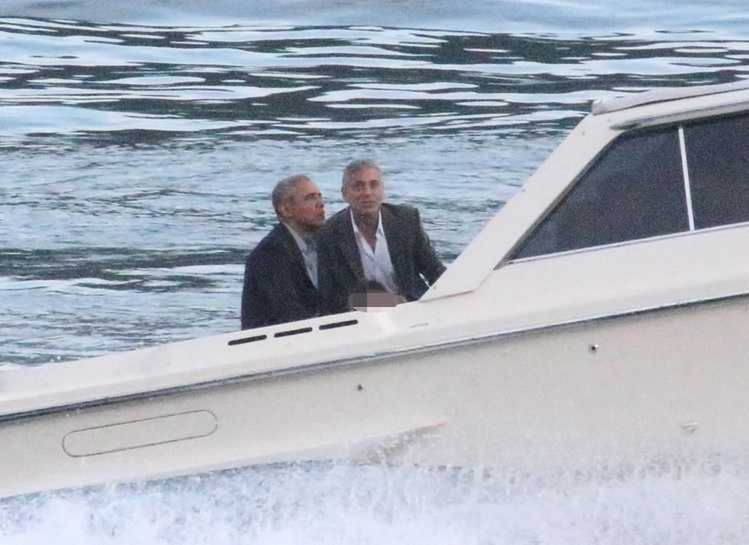 Former US President Barack Obama, left, takes a boat ride with actor George Clooney while on vacation Sunday, June 23, 2019 on Como Lake, Cernobbio, northern Italy. (Matteo Bazzi/ANSA via AP)