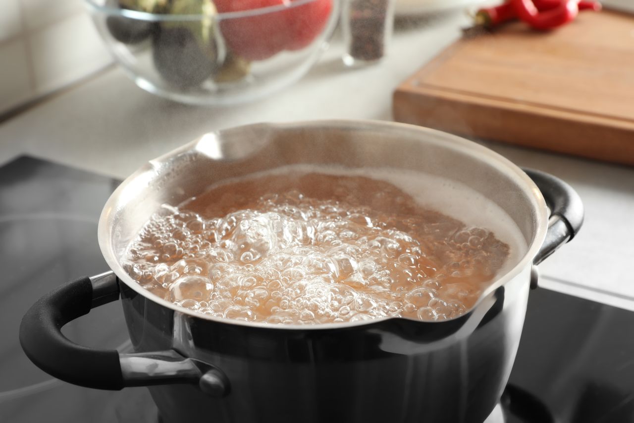 Throw a few aluminum foil balls into the boiling water.