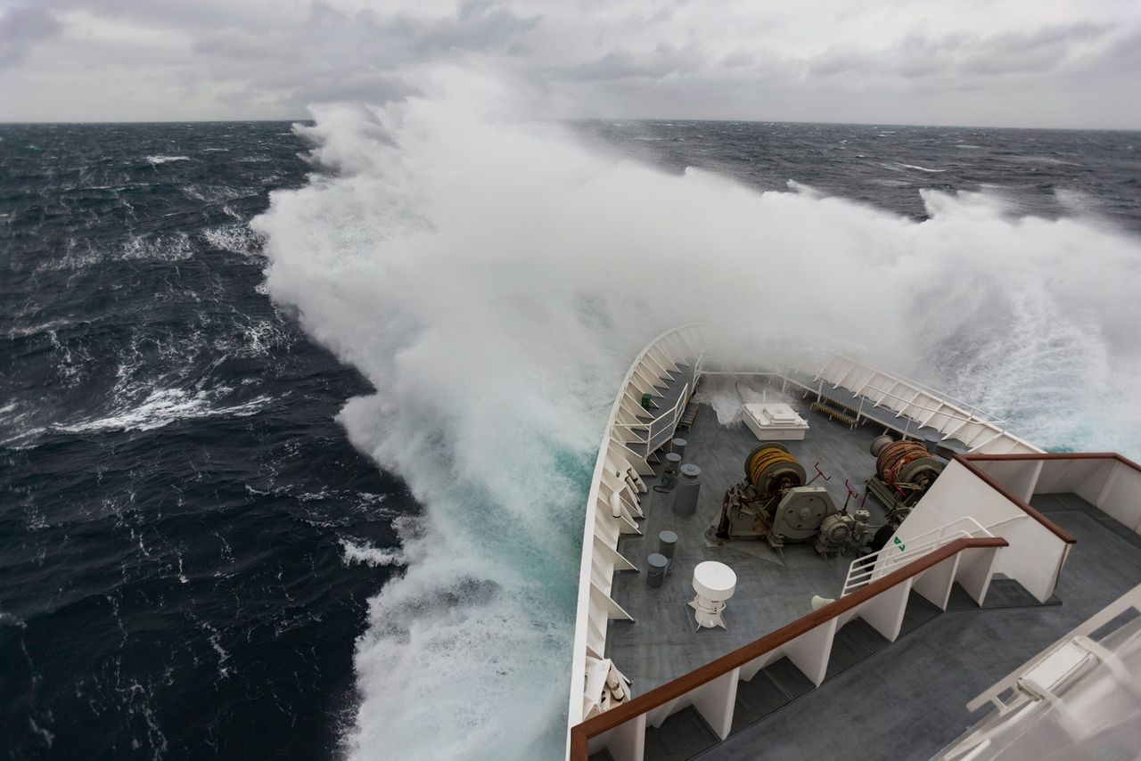 The waves crash against the cruise ship maneuvering through the Drake Passage; Antarctica. Photo: Designpics/ Adobe Stock
