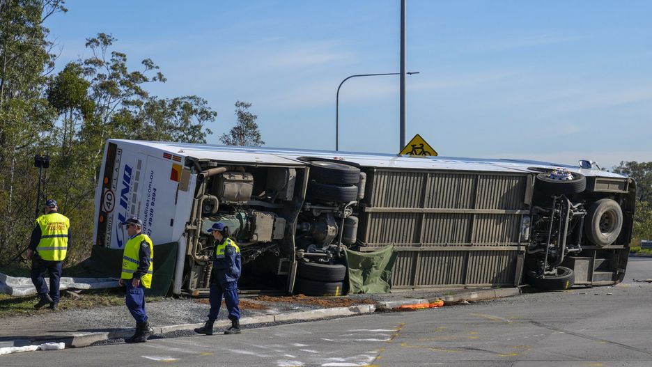 Policja sprawdza pod autobusem, który przewrócił się na bok w pobliżu Grety w Hunter Valley, na północ od Sydney, Australia, poniedziałek, 12 czerwca 2023 r