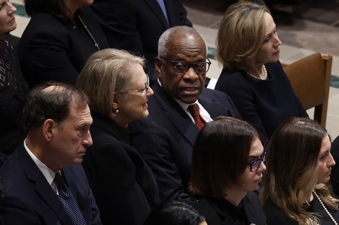WASHINGTON, DC - DECEMBER 19: Justice Clarence Thomas (2nd R) talks with his wife Virginia Thomas as they and Justice Samuel Alito, Jr. (L) attend the funeral service for late retired Supreme Court Justice Sandra Day O'Connor at Washington National Cathedral on December 19, 2023 in Washington, DC. Appointed by President Ronald Reagan in 1981, O'Connor, 93, was the first woman to serve as an associate justice on the U.S. Supreme Court before retiring in 2006.  (Photo by Chip Somodevilla/Getty Images)