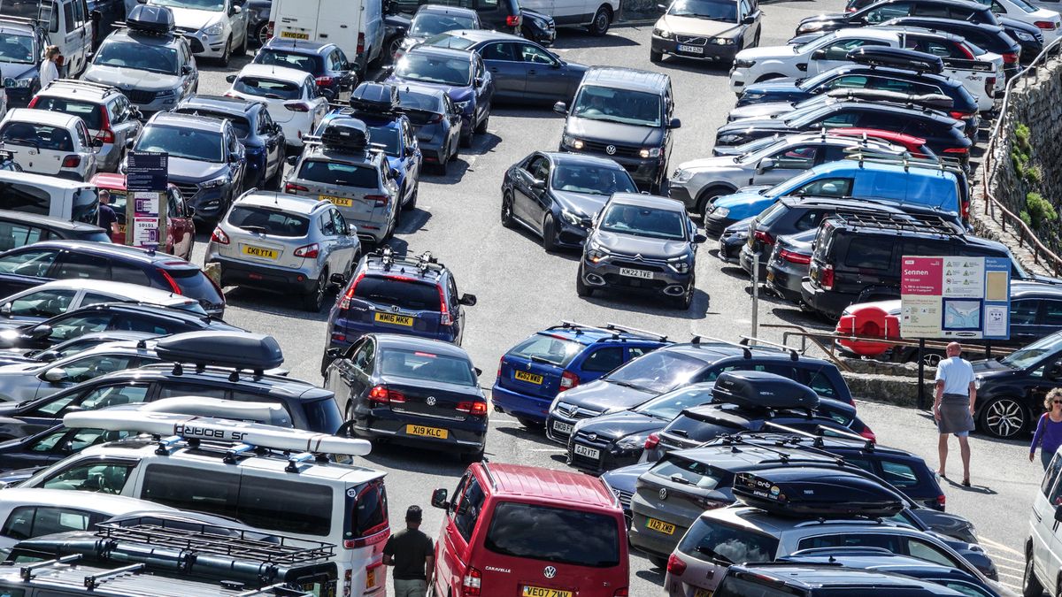 SENNEN, ENGLAND - JUNE 01: Motorists queue as they hope to get a car parking space in the already full beach car park at Sennen Cove on June 1, 2022 in Cornwall, England. In the UK and across Europe, as cars steadily become longer, wider and heavier, it has lead to what critics call "carspreading" as consumers opt for bigger and more polluting SUV type vehicles. The county of Cornwall, in the south west of England, remains one of the most popular choices for both holidaymakers opting to have a staycation in the UK and also with international visitors.  (Photo by Matt Cardy/Getty Images)
