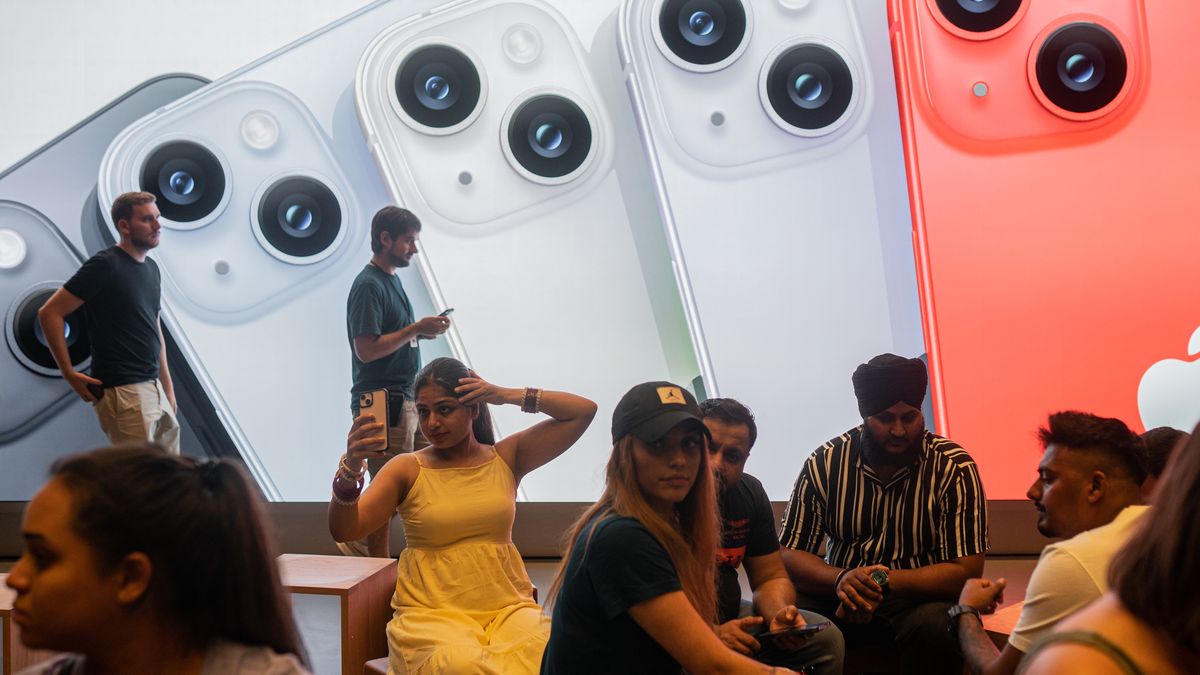 Apple salespeople serve customers who want to buy the new iPhone 14 and exchange impressions and advise them, in Barcelona, Spain, on September 16, 2022. (Photo by Marc Asensio/NurPhoto via Getty Images)