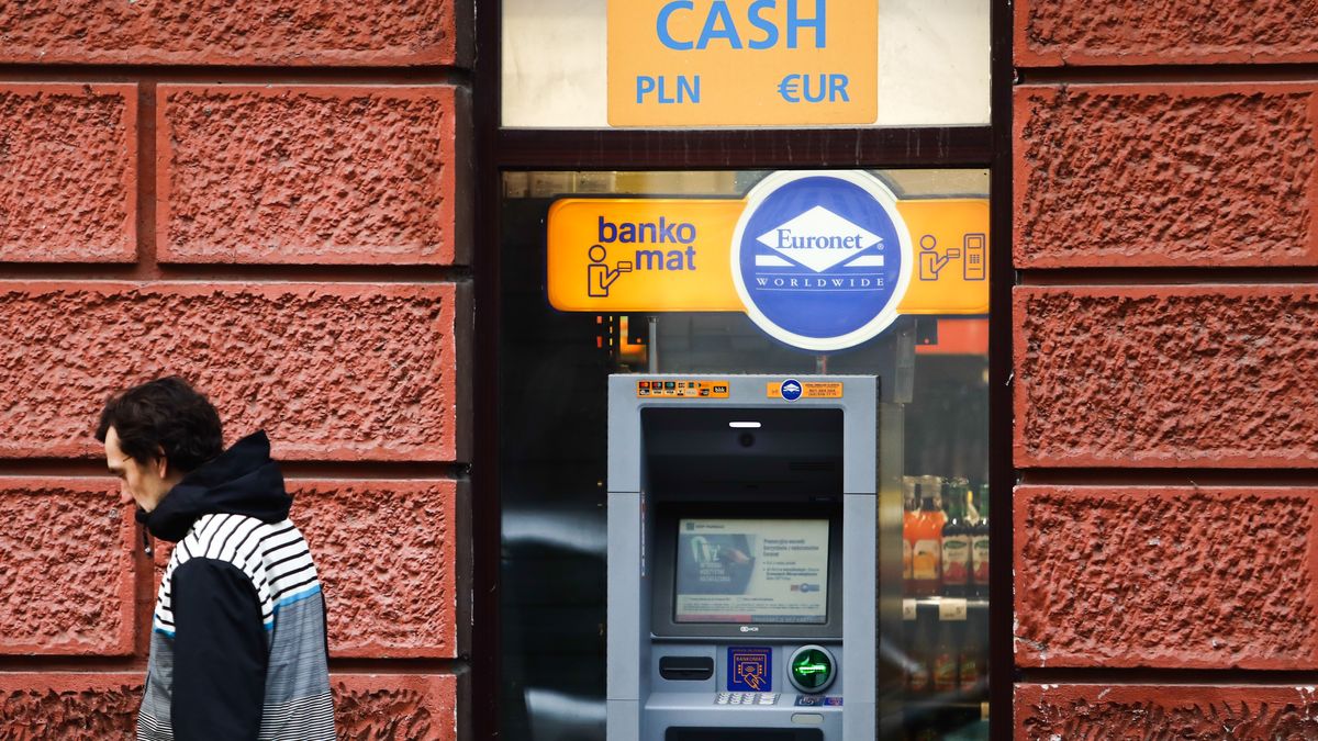 A man walks by a Euronet ATM in Krakow, Poland on January 12, 2022. (Photo by Jakub Porzycki/NurPhoto via Getty Images)