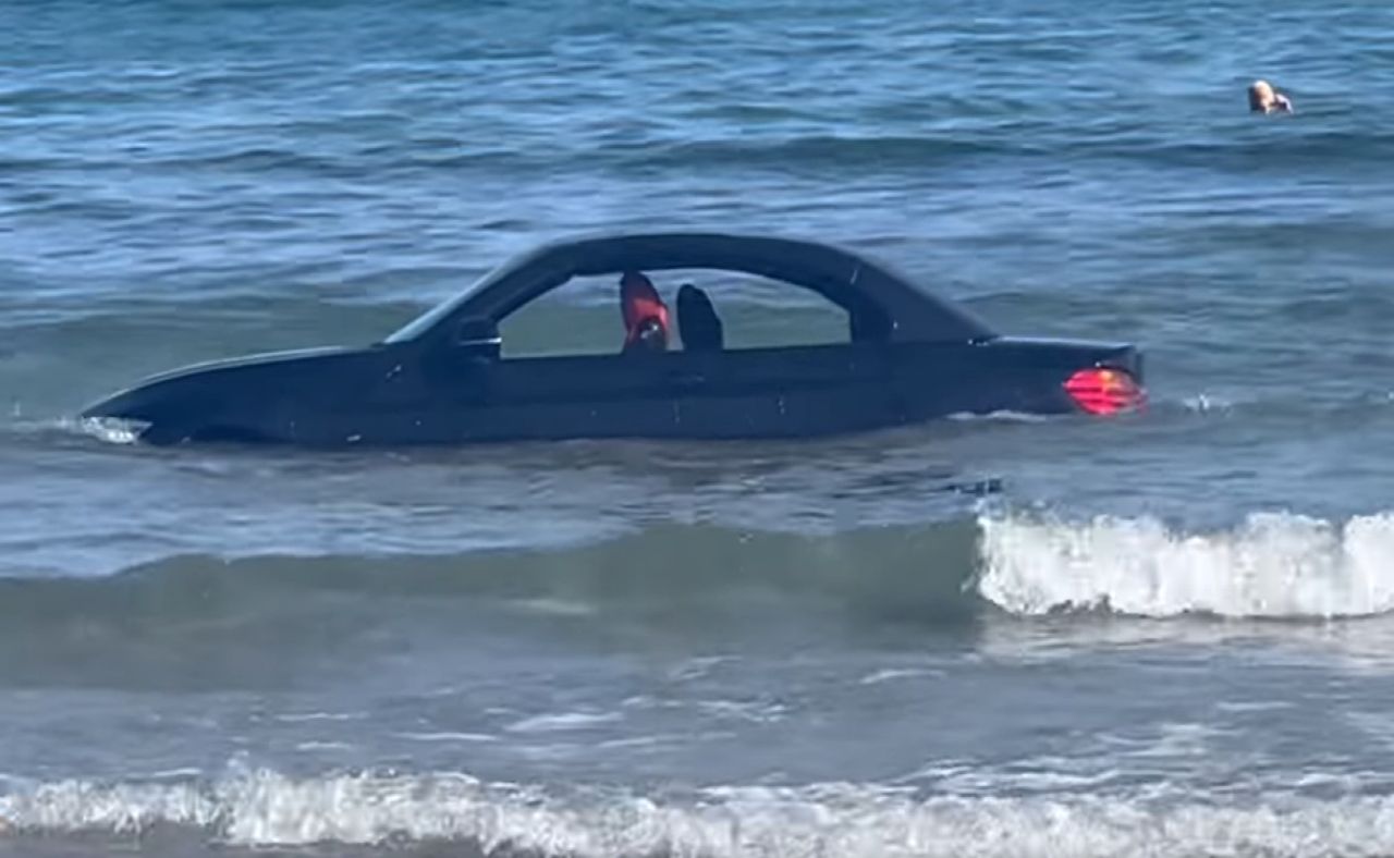 BMW takes a seaside dip: Driver's beachfront parking stunt ends in rescue operation