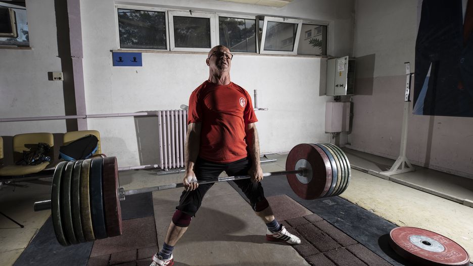 ANKARA, TURKEY - SEPTEMBER 23: 50-year-old visually impaired weightlifter Omer Galip is seen exercising at Arif Nusret Say Weightlifting Camp Training Center ahead of World Weightlifting Championship in Tbilisi from 23 to 30 October, in Ankara, Turkey on September 23, 2021. Turkish National Weightlifting Team for the Visually Impaired continues its exercises prior to the Championship that will be held in Tbilisi, the capital of Georgia. The visually impaired weightlifters, who are waiting for their branch to become the Paralympics, want to represent Turkey and receive the title of state athlete. (Photo by Ercin Erturk/Anadolu Agency via Getty Images)