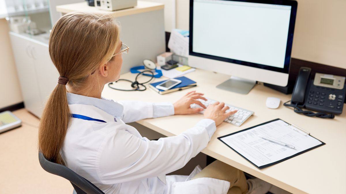 Female Doctor Working at Desk
Back view portrait of blonde female doctor sitting at desk in office working with computer, typing and looking at blank white screen, copy space
health, care, healthcare, medicine, medical, check, up, checkup, exam, examination, clinic, hospital, doctor, office, work, occupation, computer, pc, using, blank, screen, white, medic, typing, research, internet, online, professional, desk, woman, female, intern