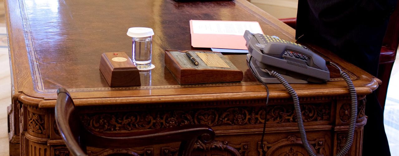 A small box with a red button on the Resolute desk