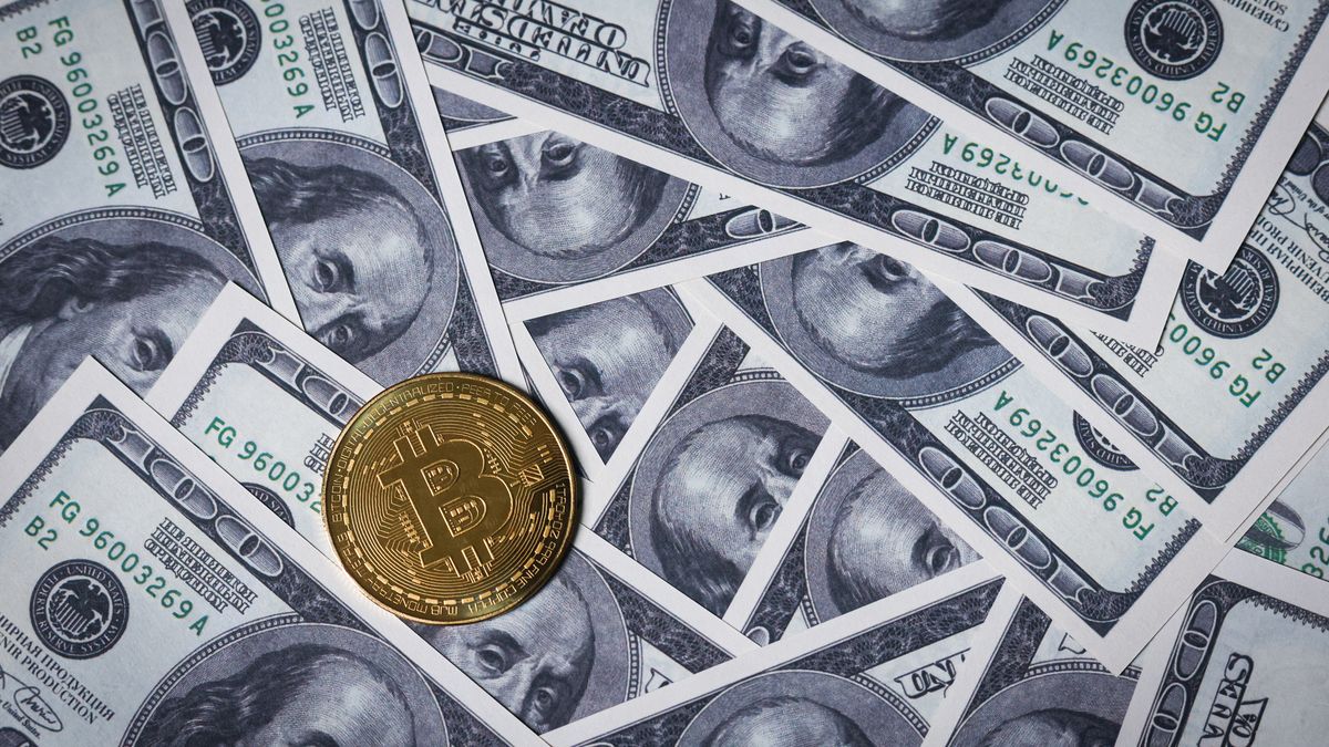 RUSSIA - 2025/01/29: In this photo illustration, the new Bitcoin token is photographed on US $100 bills featuring Benjamin Franklin. US President Donald Trump on Thursday, January 23, ordered the creation of a cryptocurrency task force tasked with developing proposals for new regulations for digital assets and exploring the possibility of creating a national cryptocurrency reserve. (Photo Illustration by Artem Priakhin/SOPA Images/LightRocket via Getty Images)
