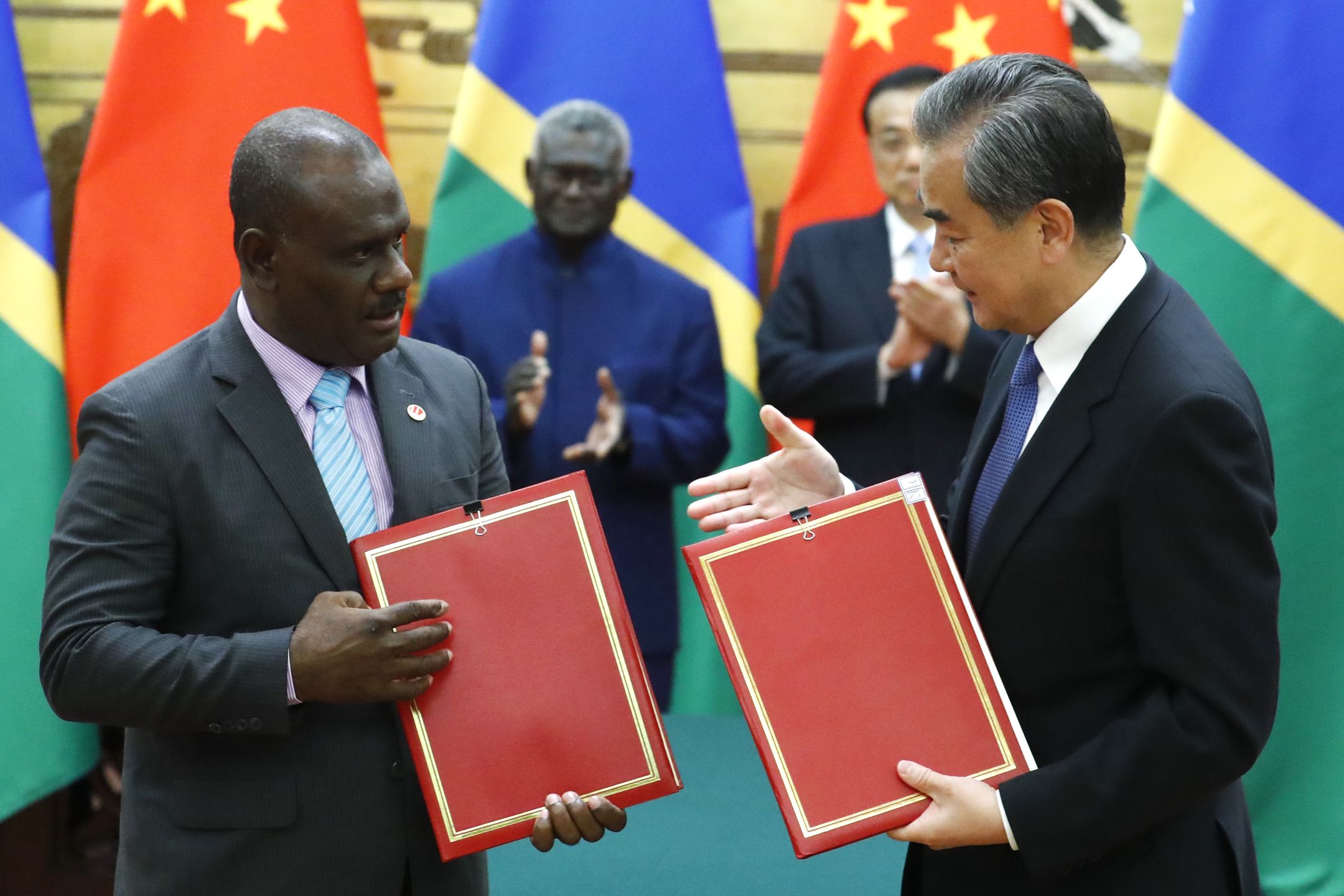 Solomon Islands Prime Minister Manasseh Sogavare attends a meeting with Chinese Premier Li KeqiangBEIJING, CHINA - OCTOBER 9: Chinese State Councillor and Foreign Minister Wang Yi and Solomon Islands Foreign Minister Jeremiah Manele attend a signing ceremony at the Great Hall of the People on October 9, 2019  in Beijing, China.  (Phtoto by Thomas Peter-Pool/Getty Images)Pool