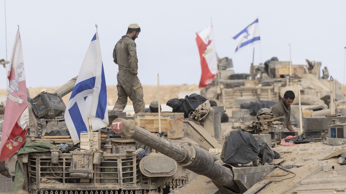 SOUTHERN ISRAEL, ISRAEL - OCTOBER 29: Israeli soldiers stand on tanks near the border with the Gaza Strip on October 29, 2025 in Southern Israel, Israel. Israeli Prime Minister Benjamin Netanyahu ordered "immediate, powerful" strikes on Gaza Tuesday, after his office accused Hamas of violating the terms of the ceasefire agreement for returning remains that Israel says do not belong to any of the 13 unaccounted for hostages. The announcement of strikes followed reports of fighting in Rafah near the "yellow line" demarcating territory under IDF control in Gaza, according to the US-brokered ceasefire agreement that came into affect on October 10. (Photo by Amir Levy/Getty Images)