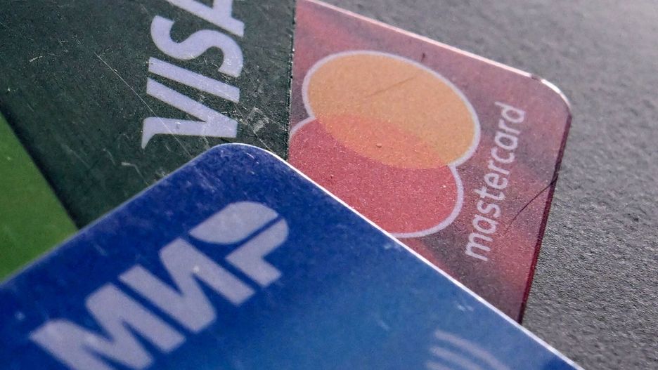 Temporary
A photo taken on March 14, 2022, shows the logos of Visa, Mastercard and Russian Mir payment systems on bank cards in Moscow. (Photo by AFP)
-