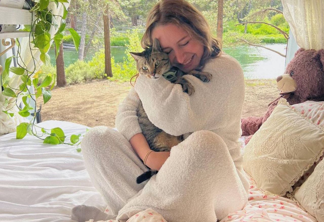 She lives in a van. The cat's litter box serves her as a chair