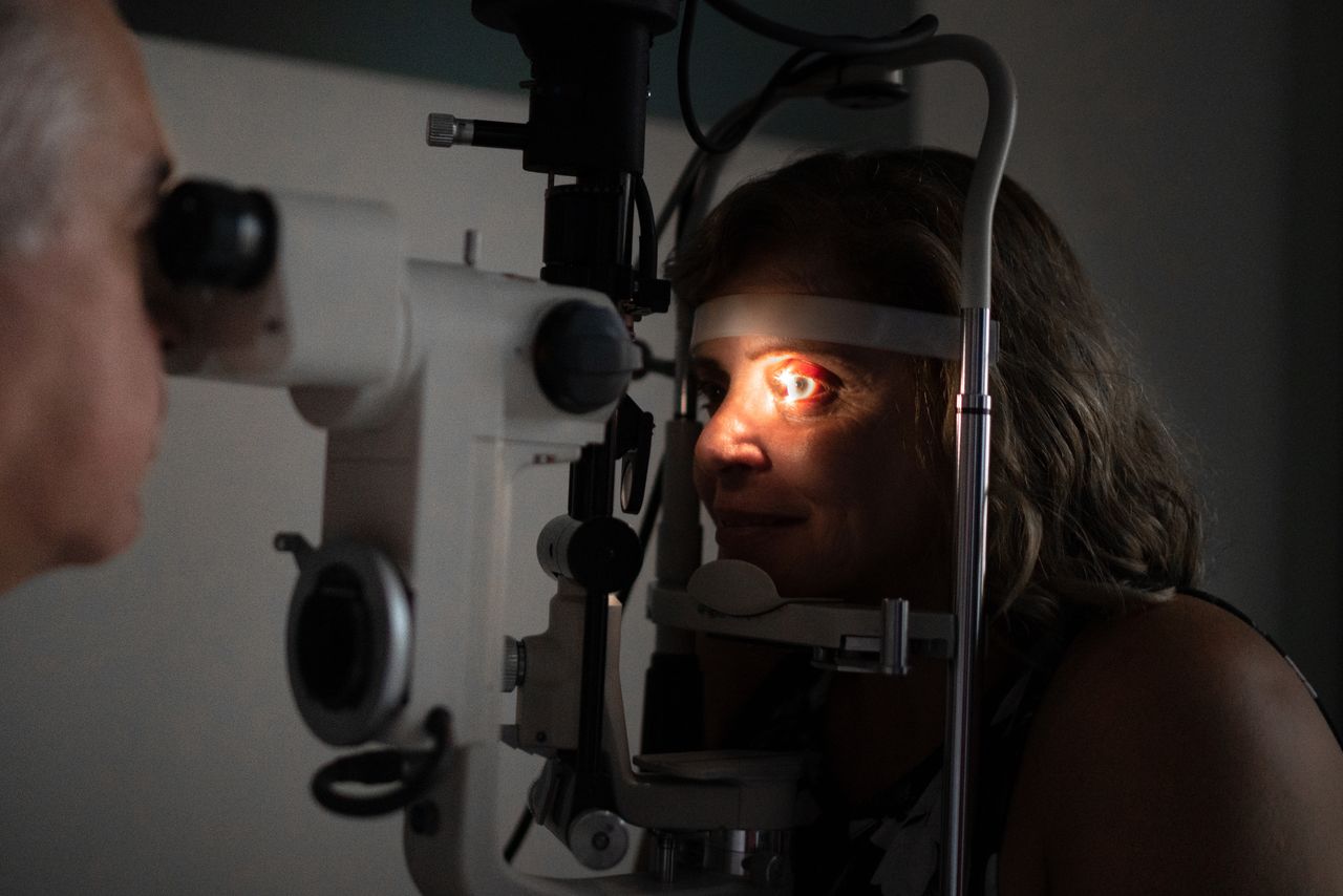 Optometrist examing patient's eyes