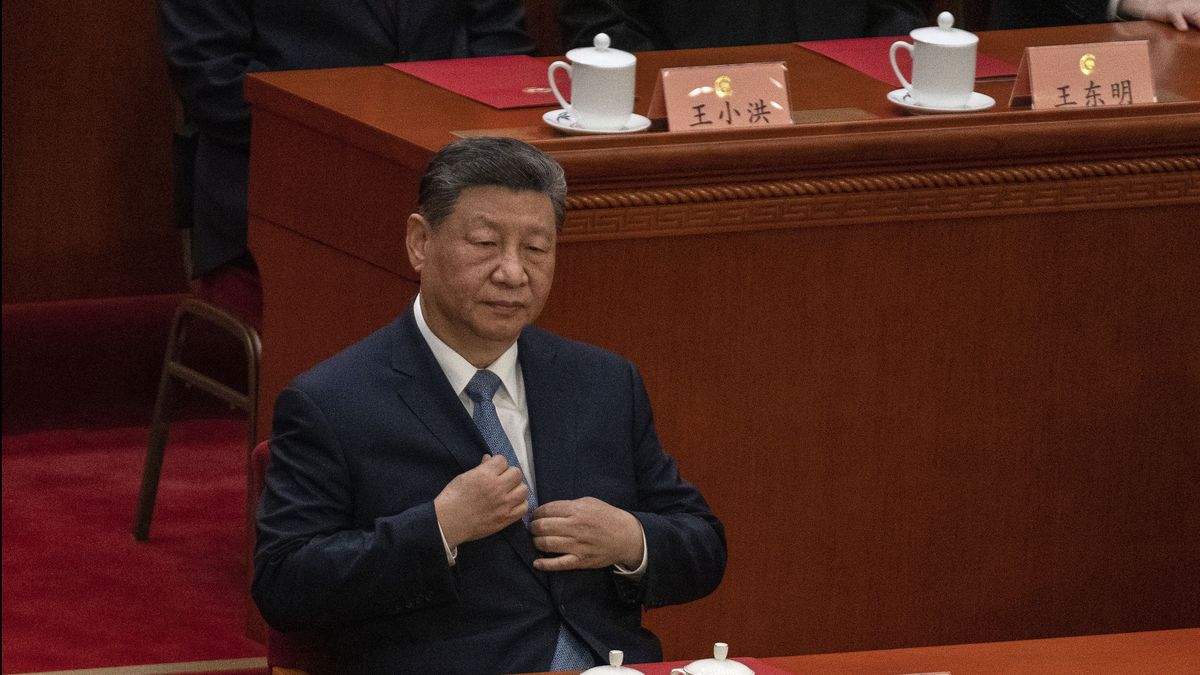 BEIJING, CHINA - MARCH 11: Chinese President Xi Jinping adjusts his jacket as he sits at the closing session of the Chinese People's Political Consultative Conference (CPPCC) at the Great Hall of the People on March 11, 2026 in Beijing, China. The fourth session of the 14th National Committee of the Chinese People's Political Consultative Conference (CPPCC), often referred to in its acronym form as CPCC meetings, begins on Wednesday in Beijing.  (Photo by Kevin Frayer/Getty Images)