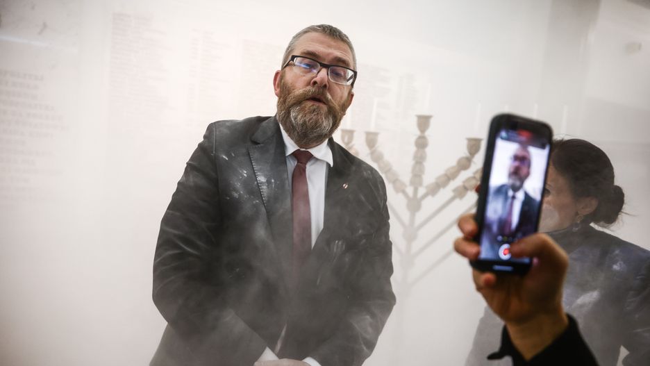 Grzegorz Braun, a member of the far-right Confederation party is seen after using a fire extinguisher on to put out candles on a menorah that was lit during Hannukah celebration in the parliament building in Warsaw, Poland on December 12, 2023.  (Photo by Beata Zawrzel/NurPhoto via Getty Images)