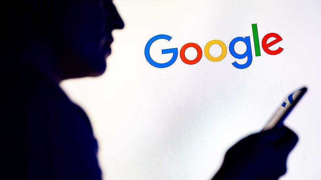 In this photo illustration, a silhouetted individual is seen
POLAND - 2025/11/26: In this photo illustration, a silhouetted individual is seen holding a mobile phone with a Google logo displayed in the background. (Photo Illustration by Mateusz Slodkowski/SOPA Images/LightRocket via Getty Images)
SOPA Images
smartphone, apps, cellphone, application, brand, logos, google