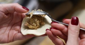 A person stuffs a traditional Polish dumpling with meat in Krakow, Poland on October 5, 2025. (Photo by Jakub Porzycki/NurPhoto via Getty Images)