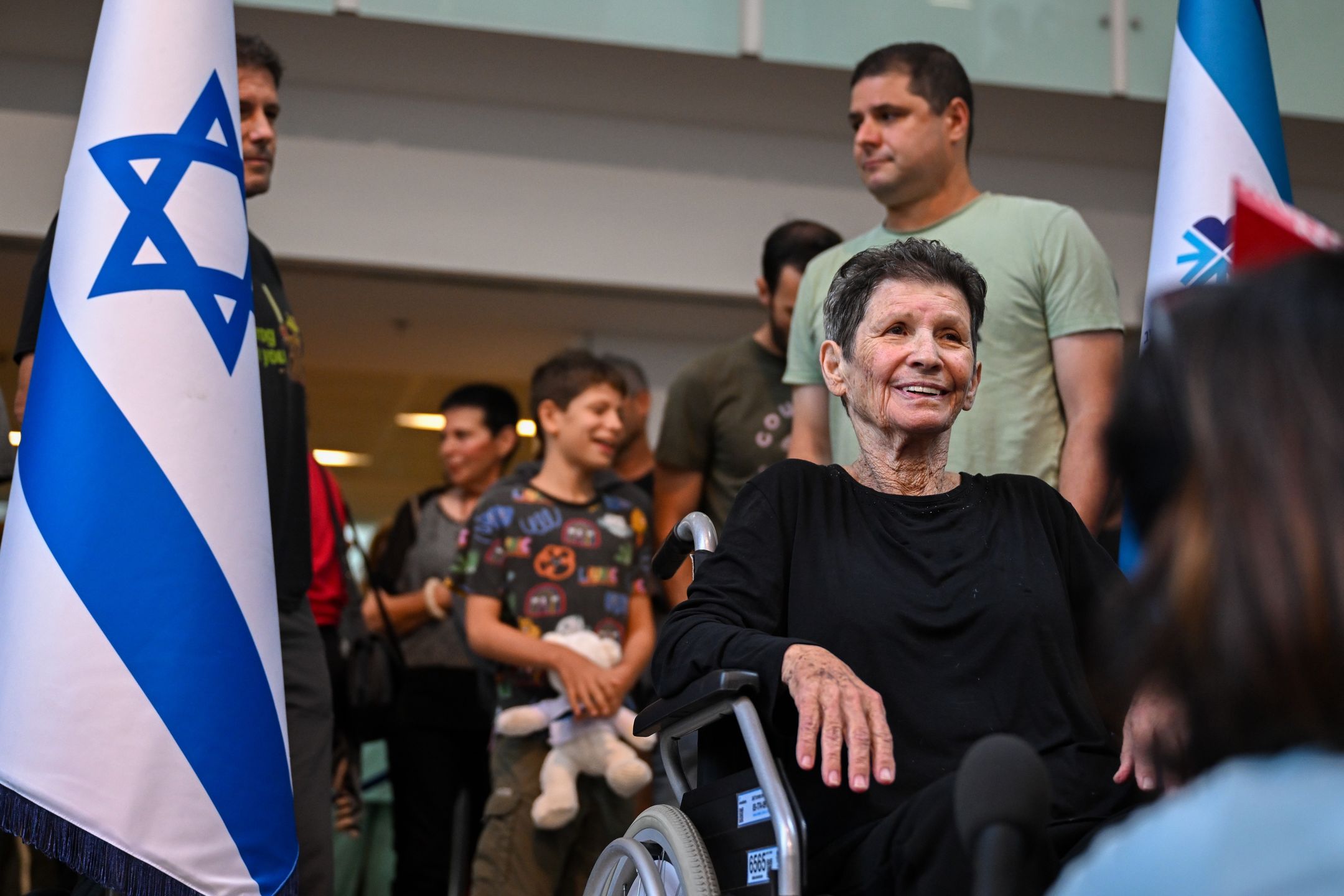 TEL AVIV, ISRAEL - OCTOBER 24: Yocheved Lifshitz (C) speaks to the media at Ichilov Hospital after she was released by Hamas last night, on October 24, 2023 in Tel Aviv, Israel. Last night, two hostages taken by Hamas on October 7th, Nurit Cooper and Yocheved Lifshitz, were released to the Red Cross within Gaza and returned to Israel. This followed the release of two other hostages, both US nationals, who were released on Saturday. (Photo by Alexi J. Rosenfeld/Getty Images)