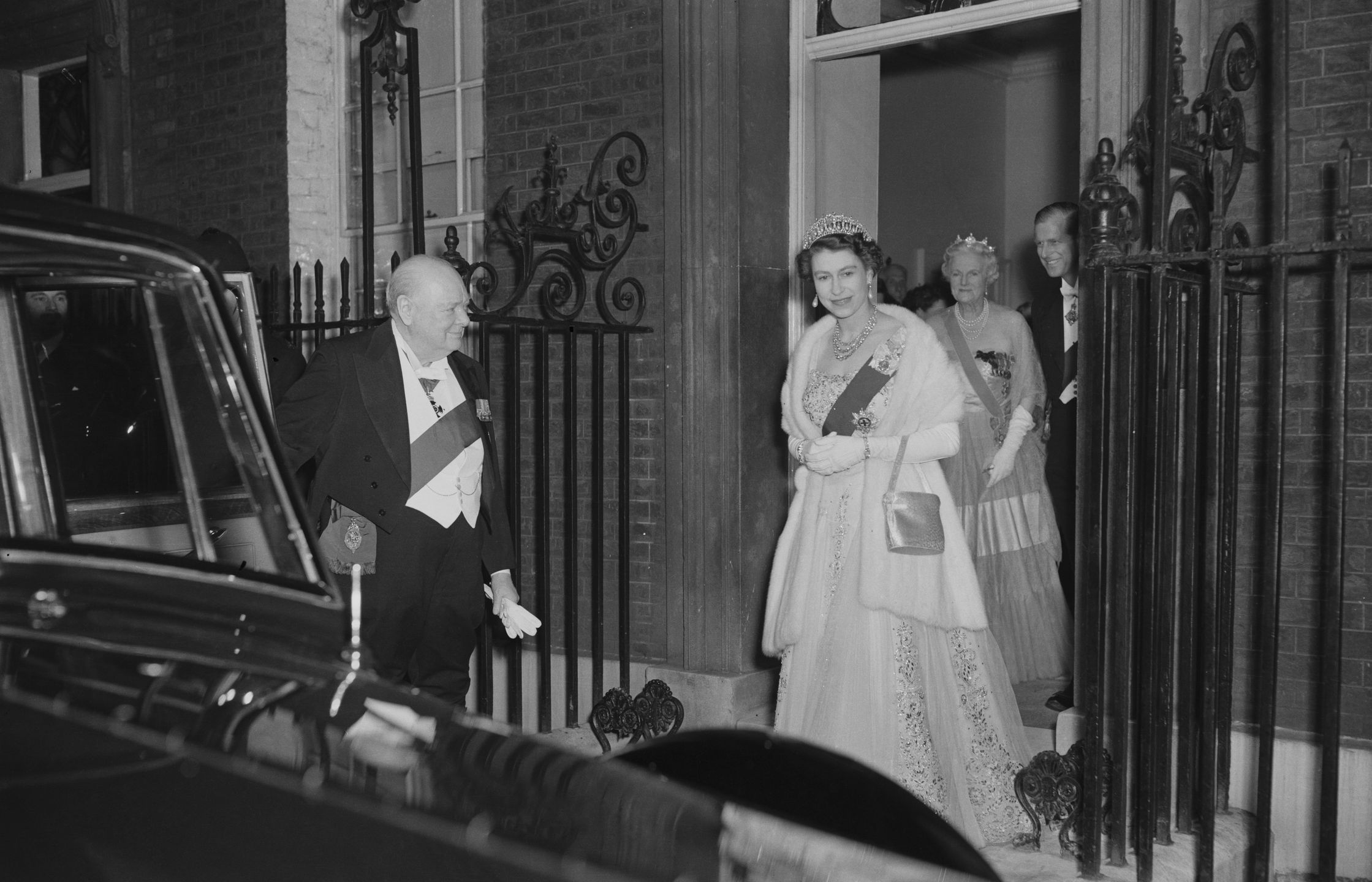 Royal GuestsQueen Elizabeth II and Prince Philip leave 10 Downing Street in London after having dinner with Sir Winston Churchill (1874 - 1965), the British Prime Minister and his wife.   (Photo by Fox Photos/Getty Images)Fox Photosformat landscape;clothing;female;male;Personality;Royalty;Sovere