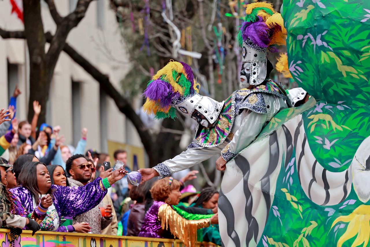 NEW ORLEANS, LOUISIANA - FEBRUARY 13: A rider hands out a coconut as the over 1,100 riders of the Krewe of Zulu make their way down St. Charles Avenue on Mardi Gras Day with their 44-float parade entitled "Celebrations and Libations Zulu Style" on February 13, 2024 in New Orleans, Louisiana. #King Zulu 2024 Melvin Labat Queen Angélique Roché# The  Zulu Social Aid & Pleasure Club stages the parade which is known for its signature hand-decorated coconuts and an eclectic cast of characters like Big Shot, Witch Doctor and Mr. Big Stuff. (Photo by Michael DeMocker/Getty Images)