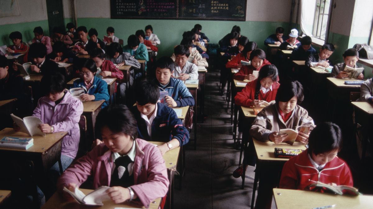 Students Reading at Their DesksChinese students sit at their desks in a classroom and read.   (Photo by Peter Turnley/Corbis/VCG via Getty Images)Peter Turnleyboy:CB3, education:CB2, girl:CB3, Beijing:CB2, class:CB3, teenager:CB3, Chinese ethnicity:CB3, blackboard:CB2, reading:CB2, textbook:CB2, student:CB3, large group of people:CB3, classroom:CB3