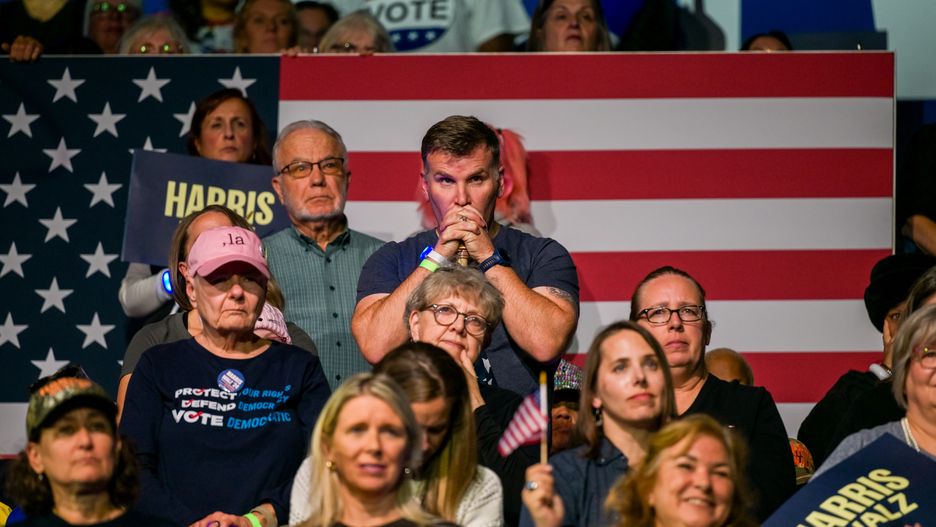 KALAMAZOO, MICHIGAN - OCTOBER 26: Attendees listen as Democratic presidential nominee, U.S. Vice President Kamala Harris speaks during a campaign rally at the Wings Event Center on October 26, 2024 in Kalamazoo, Michigan. Vice President Harris will be campaigning today with former U.S. First Lady Michelle Obama in the battleground swing state of Michigan. With 10 days remaining, Harris continues campaigning against Republican presidential nominee, former U.S. President Donald Trump ahead of the November 5 election.  (Photo by Brandon Bell/Getty Images)