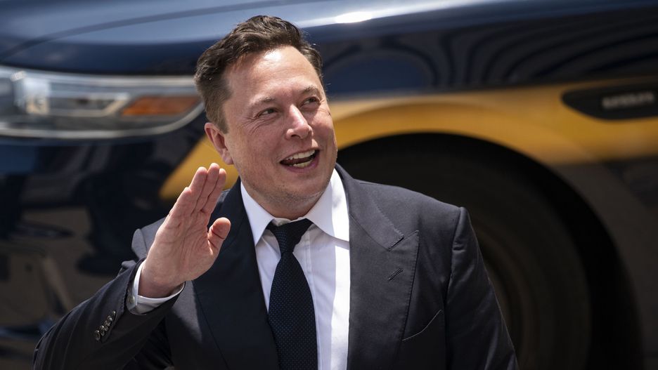 Elon Musk, chief executive officer of Tesla Inc., waves while departing court during the SolarCity trial in Wilmington, Delaware, U.S., on Tuesday, July 13, 2021. Musk was cool but combative as he testified in a Delaware courtroom that Tesla's more than $2 billion acquisition of SolarCity in 2016 wasn't a bailout of the struggling solar provider. Photographer: Al Drago/Bloomberg via Getty Images