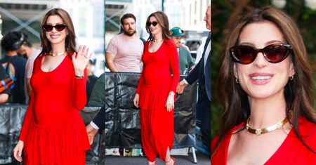 Anne Hathaway eksponuje ROSNĄCY BRZUSZEK w czerwonym kombinezonie (ZDJĘCIA)