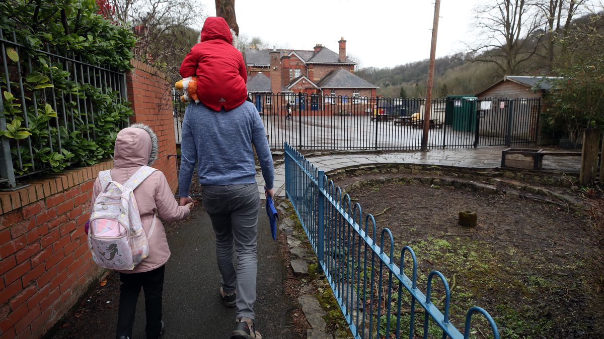 Children make their way to school after it has been announced that schools will be closing due to the coronavirus. (Photo by Nick Potts/PA Images via Getty Images)